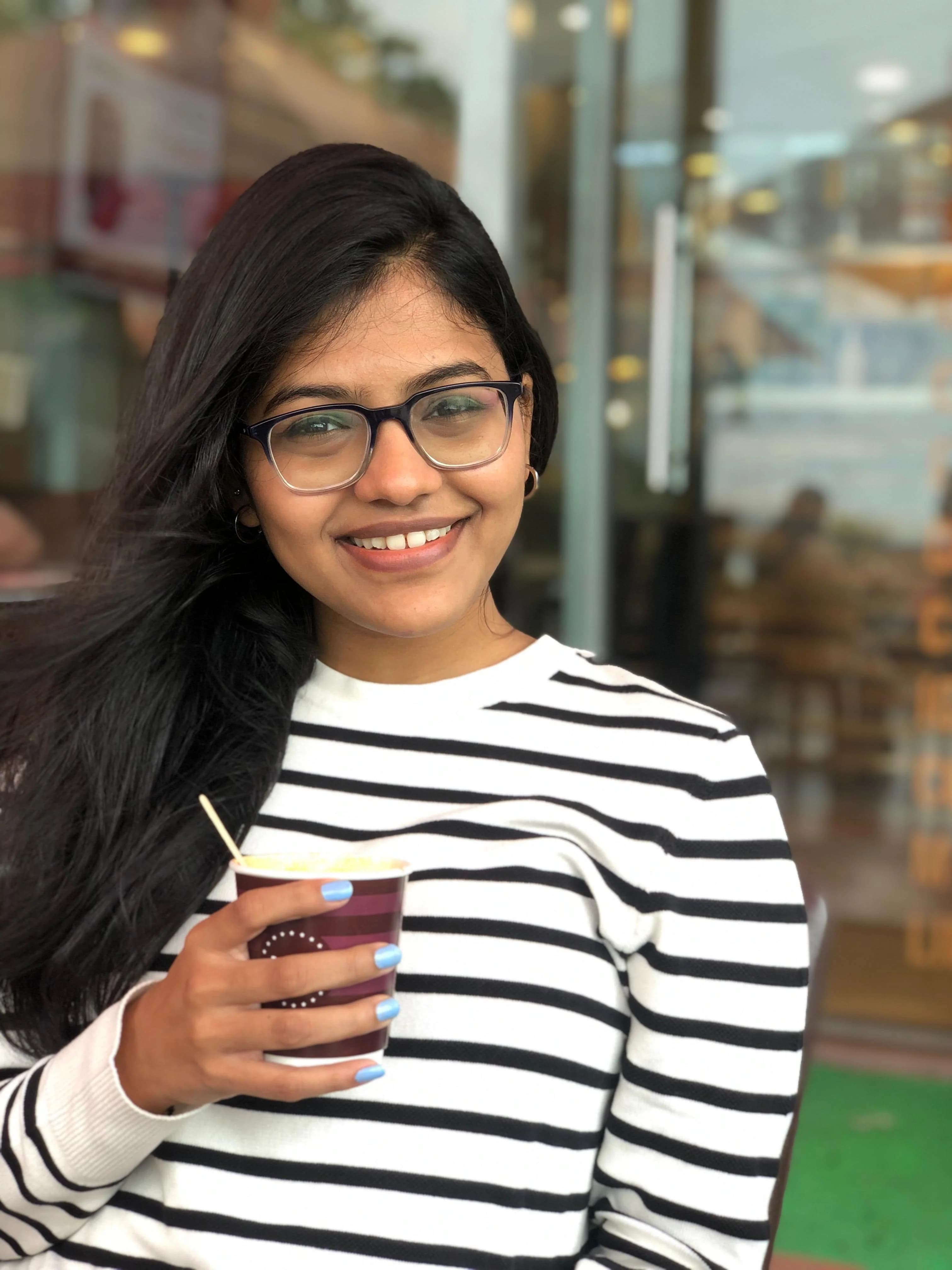 Kinnari Shah smiling with a mug